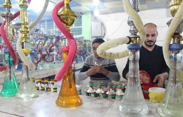 مقهى سمير أميس للارجيلة في الفلوجة فتح أبوابه من جديد للزبائن بعد انتهاء عامين من سيطرة ’الدولة الاسلامية في العراق والشام‘ فرض خلالها التنظيم قوانين صارمة في المدينة، منها منع التدخير. [سيف أحمد/ديارنا]