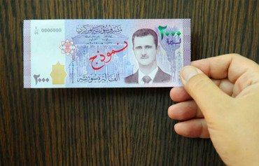 اسکناس هایی که تصویر الاسد برروی آن بود به برانگیختن تحریم ها منجر شد