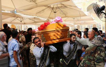 عراقيون مجندون في ميليشيات موالية لإيران للقتال في سوريا يعانون لدى عودتهم إلى البلد